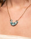 Gold paperclip chain necklace with hand-painted green-and-white Talavera ceramic crescent pendant.