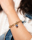 Gold chain bracelet with hand‑painted blue‑and‑white Talavera ceramic bead.