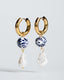 Gold hoop earrings with blue-and-white Talavera ceramic beads and baroque pearl drops.