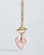 Gold paperclip toggle chain necklace with hand-painted blush pink Talavera ceramic heart pendant.