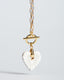 Gold paperclip toggle chain necklace with hand-painted white Talavera ceramic heart pendant.