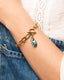 Gold toggle chain bracelet with hand‑painted green Talavera teardrop charm.