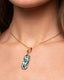 Gold chain necklace with hand‑painted green‑and‑white Talavera rectangle ceramic tile pendant.