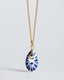 Gold chain necklace with hand‑painted blue‑and‑white Talavera ceramic teardrop pendant.