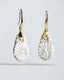 Gold hook earrings with white/gray Talavera ceramic teardrop drops.