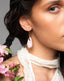 Gold hook earrings with blush pink Talavera ceramic teardrop drops.