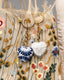 Blue and white Talavera ceramic heart keychain with gold chain hardware.