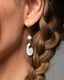 Gold hook earrings with freshwater pearl and white/gray Talavera ceramic teardrop charms.