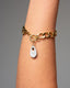 Gold toggle chain bracelet with white hand‑painted Talavera teardrop charm.