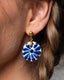 Gold ball-stud earrings with blue-and-white Talavera ceramic disc drops.