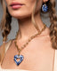 Chunky gold paperclip chain necklace with hand‑painted blue‑and‑white Talavera open‑heart ceramic pendant.